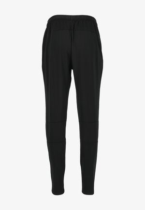 Mustat istuvat housut, joissa on joustava vyötärö, sileä pinta ja saumarakenne. Kevyt kangas. Ei näkyviä taskuja tai koristeita.