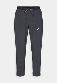 Nike meeste kitsad püksid tumehallis, millel on paela vöökoht, sile tekstuur, logo detail ja elastsed mansetid allservas.