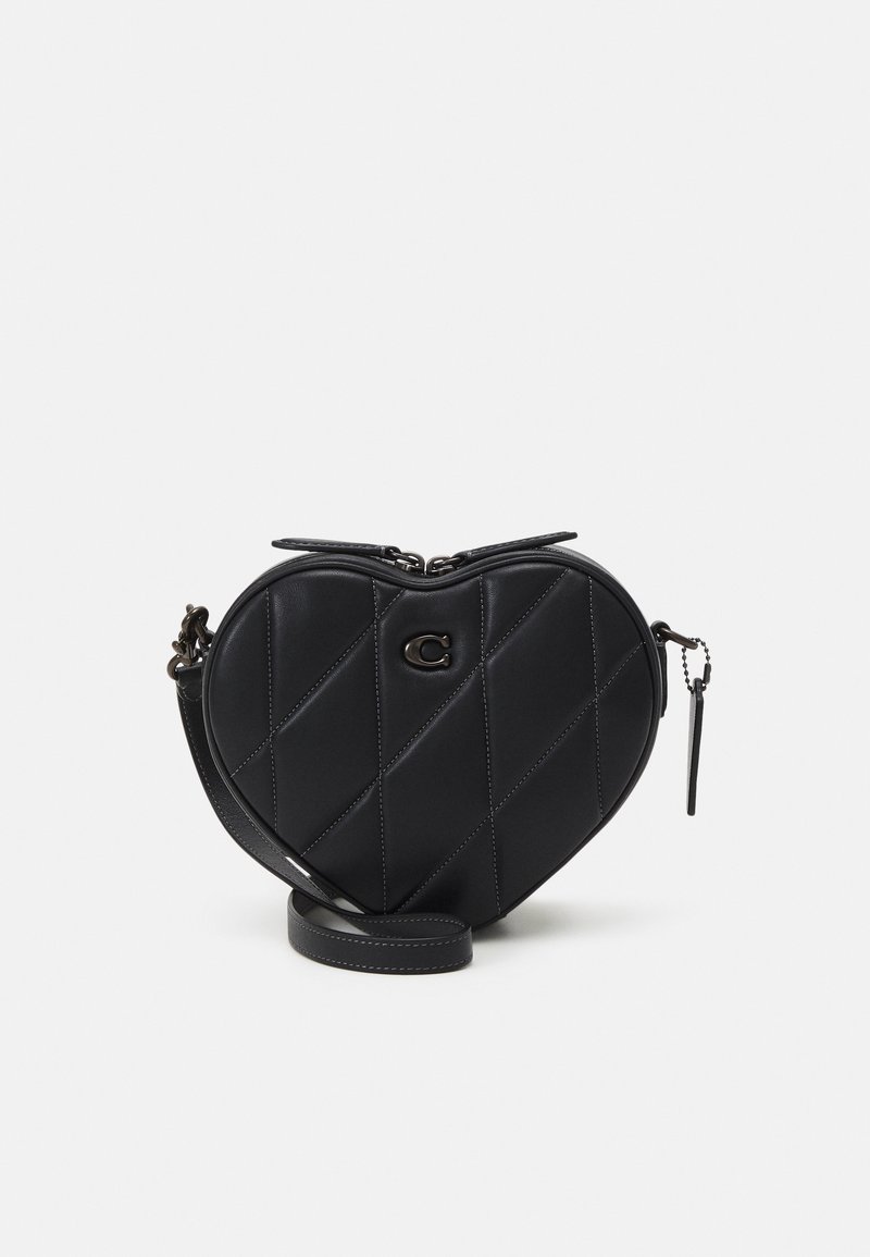 Black heart-shaped handbag made of quilted leather, featuring diagonal stitching, a zip closure, and a detachable shoulder strap.