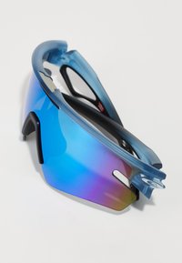 Sport sunglasses with a blue frame and mirrored gradient lenses transitioning from blue to purple. Features ventilation cut-outs and black accents.