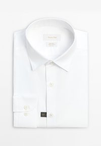 White slim fit dress shirt with buttoned cuffs, spread collar, and front buttons, neatly folded on a white background.