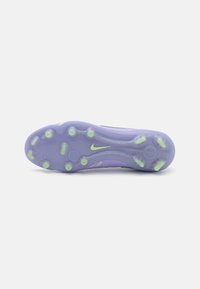 Purple sports shoe sole with translucent material and green accents, featuring circular traction nubs and a central Nike logo.