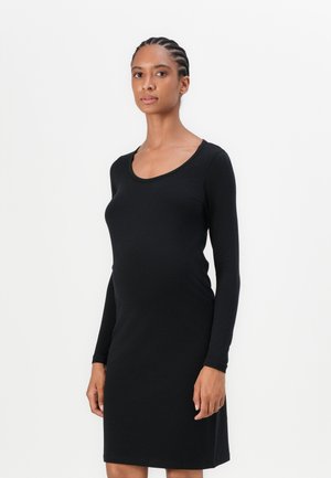 Black long-sleeve dress in soft fabric, featuring a round neckline. The dress has a fitted silhouette that falls just above the knee.