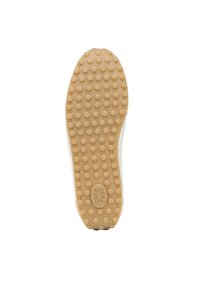 Zool van een schoen van een gemarmerd beige rubbermateriaal, met ronde nopjes voor grip en een centraal logo-label op de onderkant.