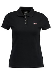 Svart polo skjorta i stretchbomull, med klassisk krage, placket med tre knappar och en liten broderad logotyp på bröstet.