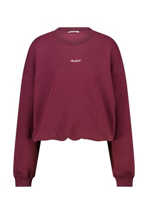 Burgundin vaaleat toppi pitkilla hihoilla, ribatilla hihansuilla ja valkoisella "New York" tekstillä brodeerattuna rintaan.