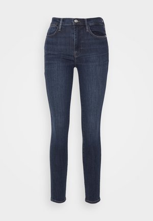 Mørkeblå høyt midje skinny jeans laget av denim, med fem lommer, diskret søm og en litt falmet tekstur.