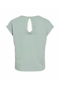 Haut vert clair à manches courtes avec un dos en forme de goutte d'eau présentant un bord en dentelle festonnée, fabriqué en tissu texturé.