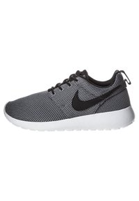 Black and gray mesh athletic shoe with a rounded shape, white sole, black laces, and a prominent black logo on the side.