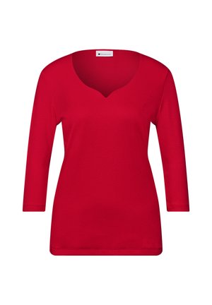 Chemise longue à manches longues pour femmes, rouge, avec un décolleté en V et un ourlet droit, présentée sur un fond blanc.