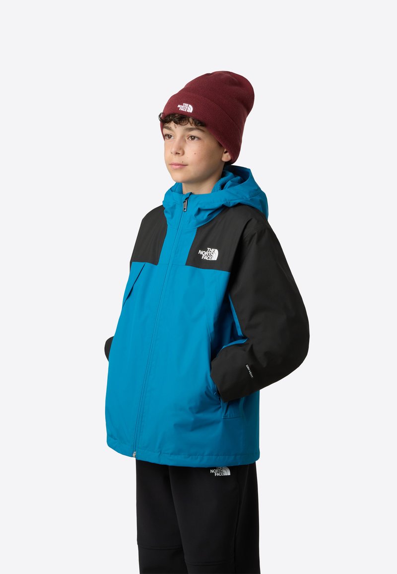 Blauw-zwart waterdicht jack met rits aan de voorkant, capuchon en elastische manchetten. Voorzien van het The North Face-logo op de borst en mouw.