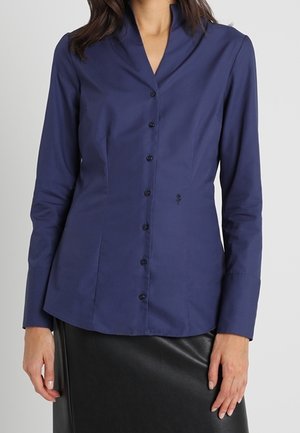 Marineblå langærmet skjorte med sjalskrave, der har et tætsiddende design og knapper foran, lavet af blødt bomuldsstof.