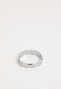 Zilveren metalen ring met een gladde, glanzende afwerking. Heeft een eenvoudige, ronde vorm en een niet-centrale opening voor gemakkelijk dragen.