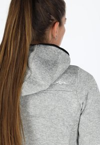 Gray hoodie with a textured finish, featuring a black collar, a hood, and a small mountain logo on the upper back.