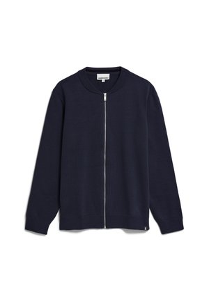 Navy zip-up cardigan made of knit fabric, featuring a round neckline, long sleeves, ribbed cuffs and hem, with a small brand label at the bottom.