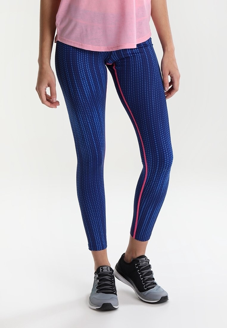 Mörkblå leggings med prickigt mönster, med rosa sid sömmar. Tillverkade av elastisk tyg, designade för komfort och rörelse.