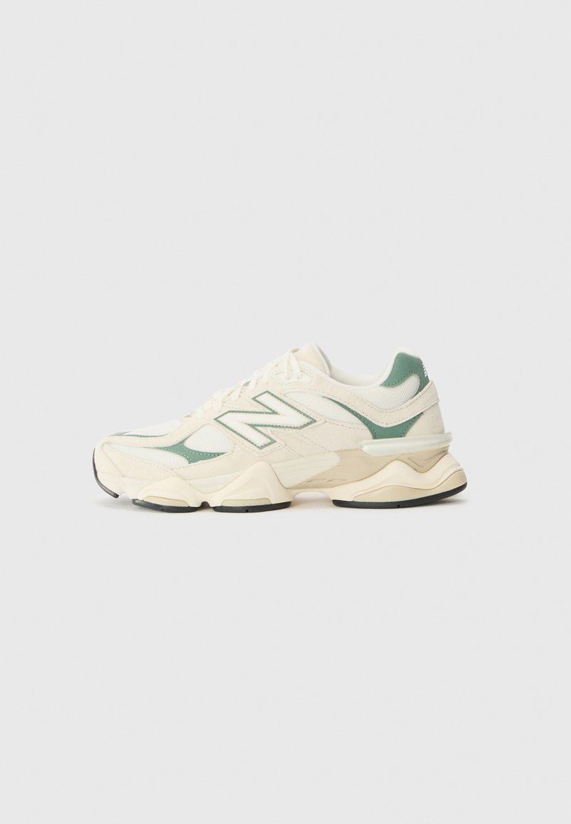 Cream and mint New Balance sneakers with mesh and synthetic overlays, thick sole, round toe, and prominent branding on the side.
