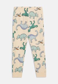 Pihe-puha pamutból készült pizsama leggings, világos bézs háttérrel, amelyen színes dinoszaurusz és madár minták láthatók.