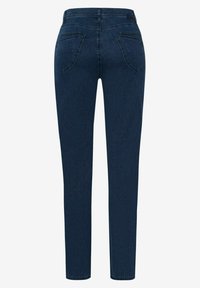 Mörkblå jeans med slim fit, femficksdesign och synlig söm. Tyget har en mjuk textur och lätt stretch.