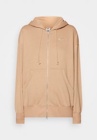 Beige full-zip hoodie med framfickor, justerbar dragsko i huvan, ribbade muddar och nederkant samt en liten Nike swoosh-logga på bröstet.