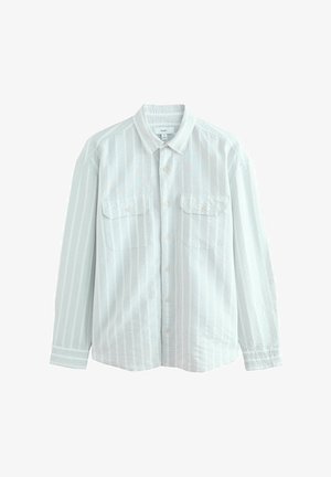 Cămașă bleu deschis, cu dungi verticale albe, două buzunare pe piept și o croială lejeră. Confecționată dintr-un material texturat.