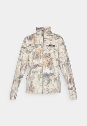 Full-zip fleece jacket with a high collar, muted camouflage woodland pattern in gray, beige, and brown, featuring a Columbia logo on the chest.