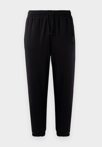 Sorte joggebukser med elastisk liv forhold, snor-lukking og elastiske mansjetter. Glatt stoff og et lite logo-patch på siden.