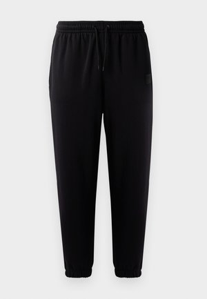 Sorte joggebukser med elastisk talje, snøre og elastiske manchetter. Glat stof og et lille logo mærke på siden.