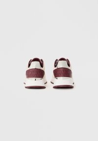 Pair of beige and burgundy sneakers with white soles shown from the back against a plain white background.