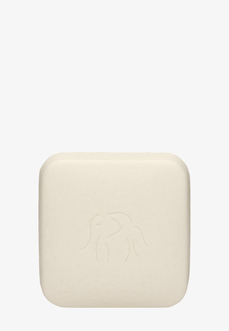Solid, square soap bar in off-white with a smooth texture; features an embossed elephant design on the surface.