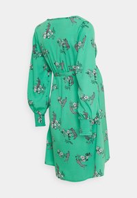 Grön klänning med blommig och leopardmönster, långa puffärmar, resår i midjan och en avslappnad passform, tillverkad av ett lätt material.