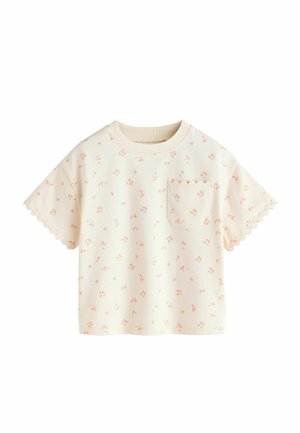 Cremefarbenes T-Shirt mit kurzen Ärmeln, kleinem rosa Blumenmuster, wellenförmigen Säumen an den Ärmeln und einer Brusttasche mit wellenförmigem Saum.