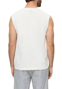 White sleeveless t-shirt made of cotton. Features a round neckline and a straight cut, with a smooth texture and minimal design.