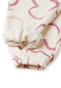 Světle krémová látka s růžovými abstraktními vířivými vzory. Elastický manžeta na zápěstí, měkká textura, ležérní design.