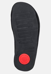 Black insole with textured surface, featuring "fitflop" branding. Includes a red circular logo labeled "MICROWOBBLEBOARD COMFORT."