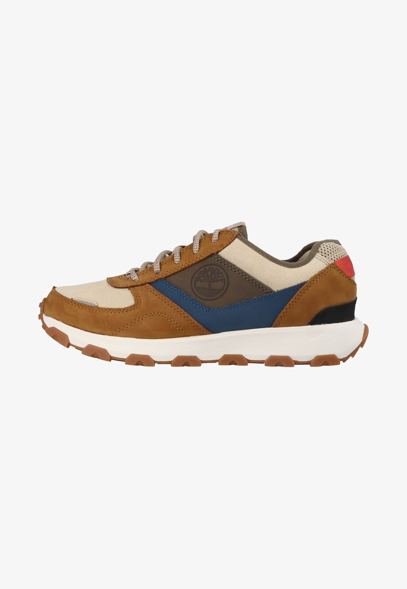 Brown and beige sneaker with blue and olive accents. Features a textured leather and suede upper, grey laces, and a white rubber outsole.