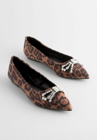 Leopardenmuster flache Schuhe mit einer spitzen Zehe und einem mit Juwelen verzierten Akzent an der Vorderseite. Hergestellt aus stoff, mit einer glatten Textur und einem kleinen Absatz.