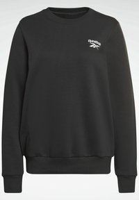 Sudadera negra hecha de mezcla de algodón. Presenta un cuello redondo, mangas largas, puños acanalados y un pequeño logo blanco de Reebok en el pecho izquierdo.