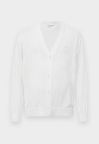 White knitted cardigan with a v-neck, ribbed texture, five buttons down the front, and a small embroidered logo on the left chest.