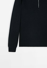 Dark navy knit sweater with long ribbed sleeves, a quarter-zip neckline, and a smooth texture. Simple design, no visible patterns or hardware.