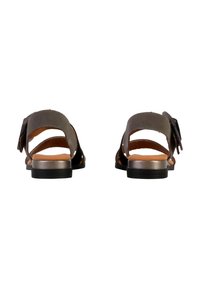 Gray suede sandals with an open back, featuring multiple straps and a flat black sole. A bow accent is visible on one side.