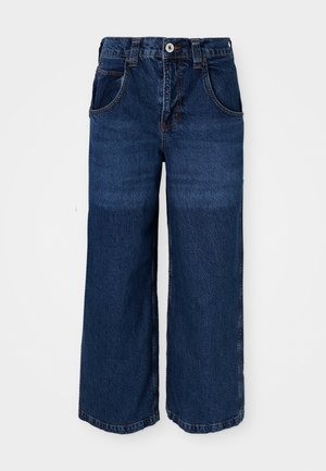 Bredde ben mørkeblå jeans laget av denim. Har fem lommer, knappelukking og synlig søm med en lett falmet tekstur.