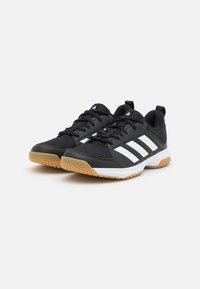 Black athletic shoes with mesh upper, three white stripes, and gum rubber outsoles. Features laces and a padded collar for comfort.