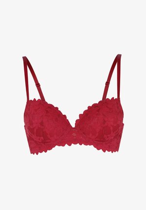 Reggiseno rosso in pizzo con bordo a zig-zag, motivo floreale, coppe con supporto e spalline in satin regolabili. Il tessuto testurizzato aggiunge dettaglio.