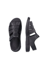 Sandales noires avec un design à bout fermé et talon ouvert, dotées de brides horizontales, d'un matériau texturé et d'une semelle en caoutchouc robuste.
