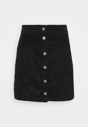 Mini-jupe en velours côtelé noir avec fermeture boutonnée à l'avant et deux poches plaquées.