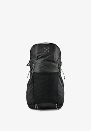 Sac à dos de randonnée noir avec couvercle supérieur, poche avant en mesh, sangles latérales et logo réfléchissant sur le panneau avant supérieur.
