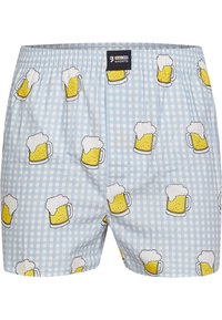 Boxer in tessuto a quadretti blu con illustrazioni ripetute di boccali di birra. Vita elastica e tessuto leggero con una texture liscia.