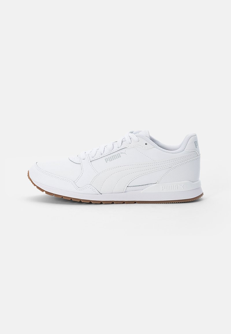 White athletic shoes with a smooth leather upper, round toe, and a low profile. Features a rubber sole with a brown traction pattern and logo accents.