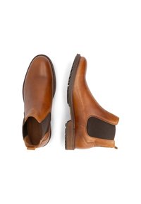 Bruine leren Chelsea-boots met elastische zijkanten, ronde neus, gestructureerde zool en een lus voor eenvoudig aan- en uittrekken.